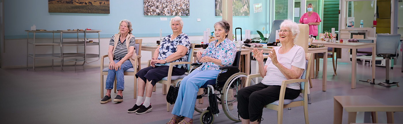 two ladies in chairs participating in a movement exercise